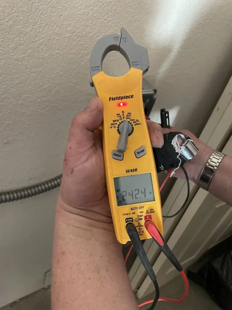 Voltage testing with clamp meter during Whole House Surge Protector in Arlington Heights